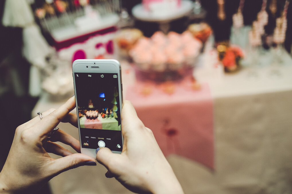 Panoramski pogled na slatki sto sa flamingo dekoracijom, cupcakes, makaronima i Moët šampanjcem